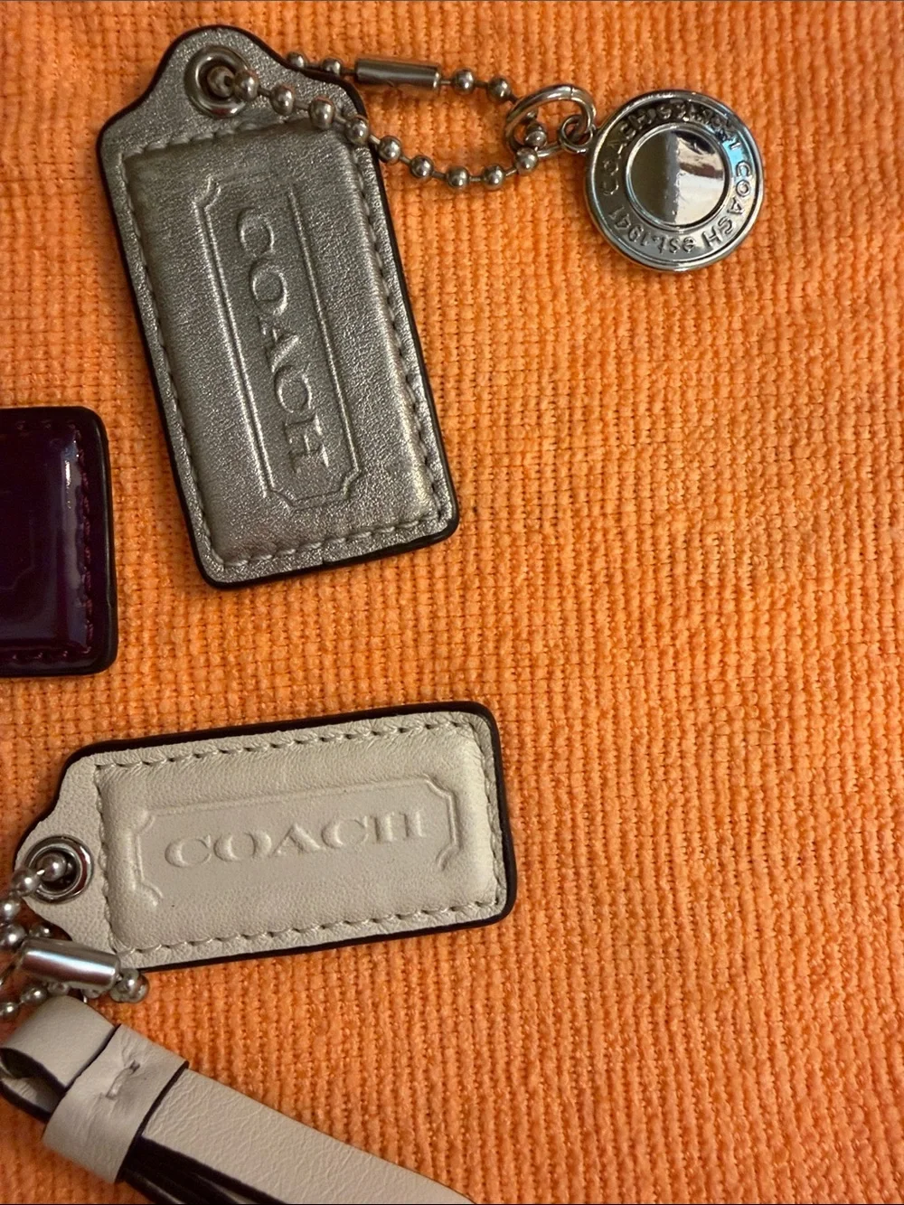 Coach Trio of Leather and Patent Tag Charms with Cream Wristlet